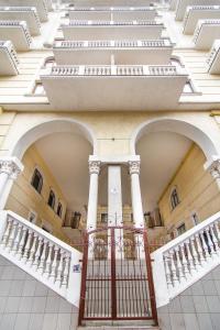 a building with white columns and a staircase at Modern Apartment in the city center in a new building in Odesa