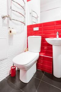 a bathroom with a white toilet and a sink at Modern Apartment in the city center in a new building in Odesa +21 photos