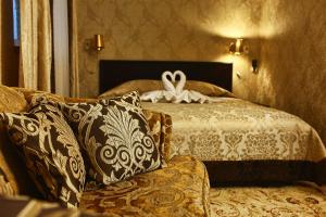 a bedroom with a bed with a swan on it at Classic Hotel in Pyatigorsk