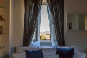 a living room with a couch and a large window at White House in Orvieto