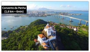 a view of a river with a bridge in the background at Flat Pasárgada 404 in Vila Velha