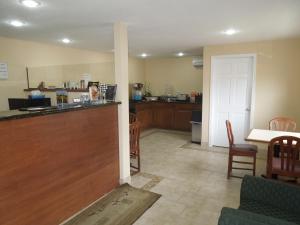 a waiting room with a counter and a kitchen at Budget Inn Watkins Glen in Watkins Glen