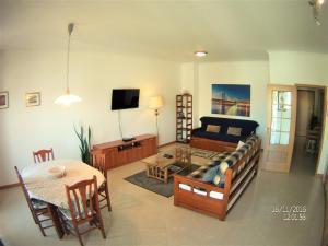 a living room with a couch and a table at Albufeira Bicos Beach Apartment in Albufeira