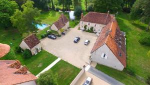 an aerial view of a large house with cars parked at Le Parc des Aubiers in Brion