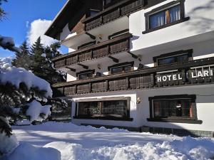 a hotel building with snow in front of it at Hotel I Larici in Bardonecchia