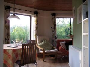 a dining room with a table and chairs and a window at Drombrow Cottage in Bantry