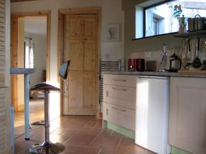 a kitchen with a sink and a counter top at Drombrow Cottage in Bantry +6 photos