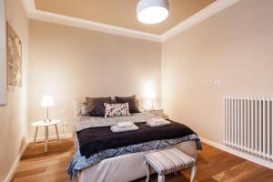 a bedroom with a large bed in a room at Suite cuore di Lucca - 2 smart TV - Heart of Lucca in Lucca +6 photos