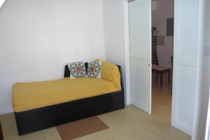 a small bedroom with a bed with a yellow blanket at Pez 106 in Bayahibe +42 photos