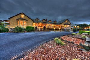 a large house with a driveway in front of it at Stanley Seaview Inn in Stanley