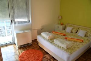 a bedroom with a bed with two pillows on it at Apartment with free parking Marija in Niš