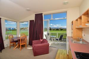 a kitchen with a table and a dining room with a view at Parkside Motel in Richmond