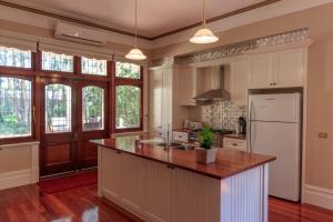 a kitchen with a white refrigerator and a counter at The Oaks Lilydale Accommodation in Lilydale