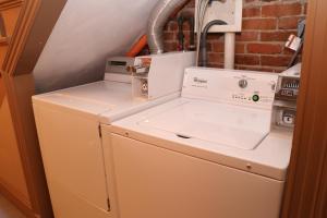 a washer and dryer sitting on top of a refrigerator at Cheap, Furnished Studio in Downtown Boston #7 in Boston