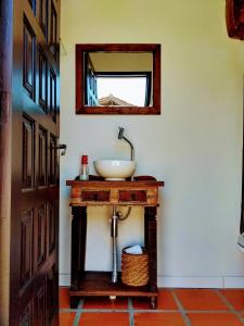 a bathroom with a sink and a mirror at The Cats' House in Florianópolis