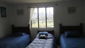 Postel nebo postele na pokoji v ubytování Hostal Casa Lantana