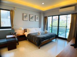 a bedroom with two stuffed animals sitting on a bed at Unicehome in Tainan