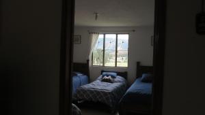 Postel nebo postele na pokoji v ubytování Hostal Casa Lantana