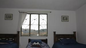 Postel nebo postele na pokoji v ubytování Hostal Casa Lantana