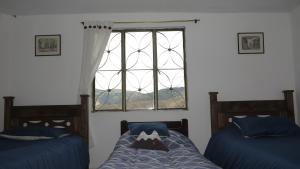 Postel nebo postele na pokoji v ubytování Hostal Casa Lantana