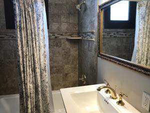 a bathroom with a sink and a mirror at Riverside Hot Springs Inn & Spa - Adults Only in Lava Hot Springs