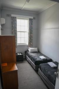 a room with two beds and a window at Castlereagh Hotel in Dubbo