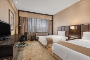 Postel nebo postele na pokoji v ubytování Holiday Inn Mudanjiang by IHG