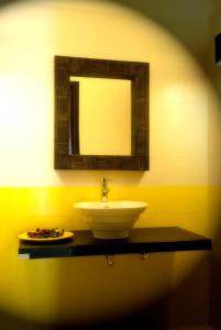 a bathroom with a sink and a mirror at Il Profumo dei Sensi in Pollica