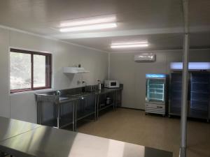 
a kitchen with a refrigerator and a counter top at Peoples Park in Coral Bay
