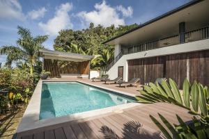 a swimming pool in the backyard of a house at Te Ravaki Estate in Rarotonga