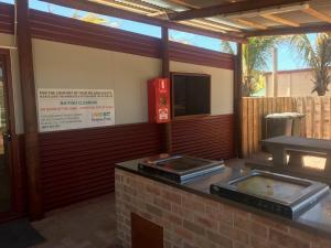 a kitchen with two trays on top of a counter at Peoples Park in Coral Bay