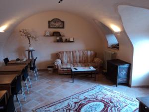 a living room with a couch and a table at Bed&Breakfast Giardini di Corte in Toscolano Maderno