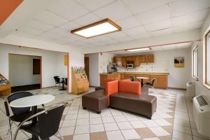 a room with a table and chairs and a kitchen at Motel 6-Davenport, IA in Davenport