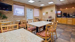 a restaurant with tables and chairs and a kitchen at SureStay Hotel by Best Western Camarillo in Camarillo