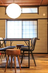 a table and chairs in a room with a window at TAMACO in Kanazawa in Kanazawa