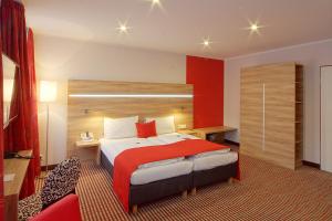 
Ein Bett oder Betten in einem Zimmer der Unterkunft das seidl - Hotel & Tagung - München West
