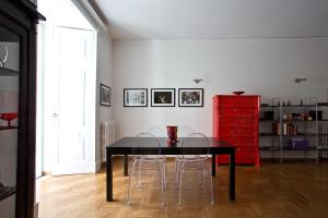 a dining room with a black table and a red dresser at Bella Napoli Art Gallery in Naples