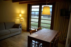 a living room with a table and a couch at Pietre Gemelle Resort in Alagna Valsesia