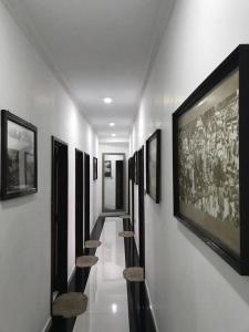 a hallway with a bunch of pictures on the wall at Eagle's Residence in Kandy