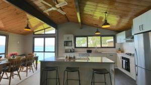 una cocina con una gran isla con taburetes de bar en Pukaki Lakeside Getaway NZ, en Lago Pukaki