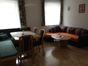 a living room with a couch and a table at Ferienwohnung Moritz in Kaunertal