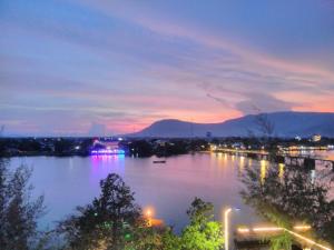 a view of a river at night with lights at Good Morning Kampot in Kampot