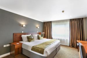 A bed or beds in a room at Stoke By Nayland Hotel, Golf & Spa 