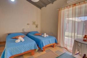 A bed or beds in a room at Lefkes Apartments