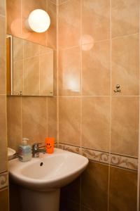 a bathroom with a sink and a mirror at Comfort Apartment in Pomorie