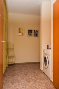 a laundry room with a washing machine and a washer at Comfort Apartment in Pomorie