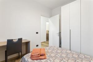 a bedroom with a bed and a desk and a chair at Casa Dany in Cassola