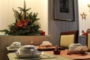 a dining room table with a christmas tree on the wall at Hotel Jardim Viana do Castelo in Viana do Castelo
