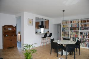 a dining room with a table and chairs and a library at Boutique Apartment in Chalandri in Athens