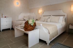 A bed or beds in a room at Dimora Sighé, exclusive rural villa with hydromassage pool